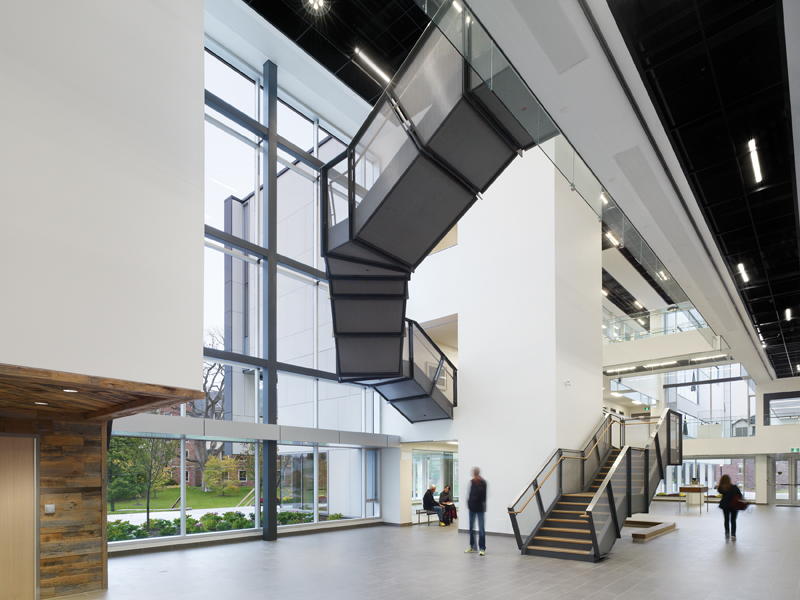 A sculptural staircase adds a dynamic presence to the main space.