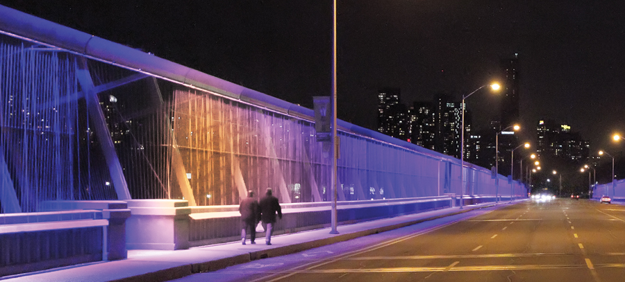 Purple hues ripple through the metal strings of the Luminous Veil, a suicide barrier atop Toronto’s Prince Edward Viaduct. (Photo: James Anthony Usas)