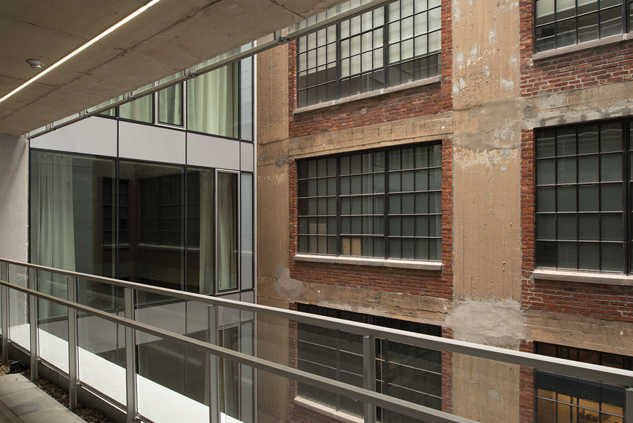 The brick side elevation of the Unity Building encloses the courtyard