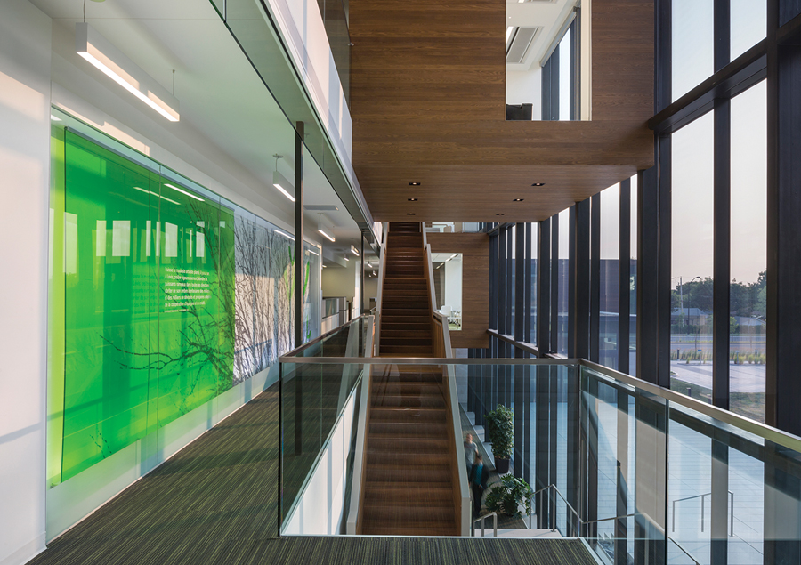 Wood staircases rise alongside the façade