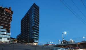 A light-box addresses a highway ramp adjacent to the project’s south side.